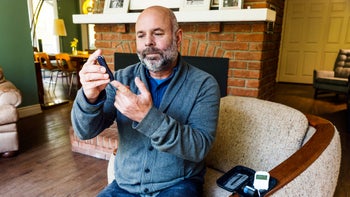 Health: Diabetes type 2: man with diabetes checking sugar 865903474