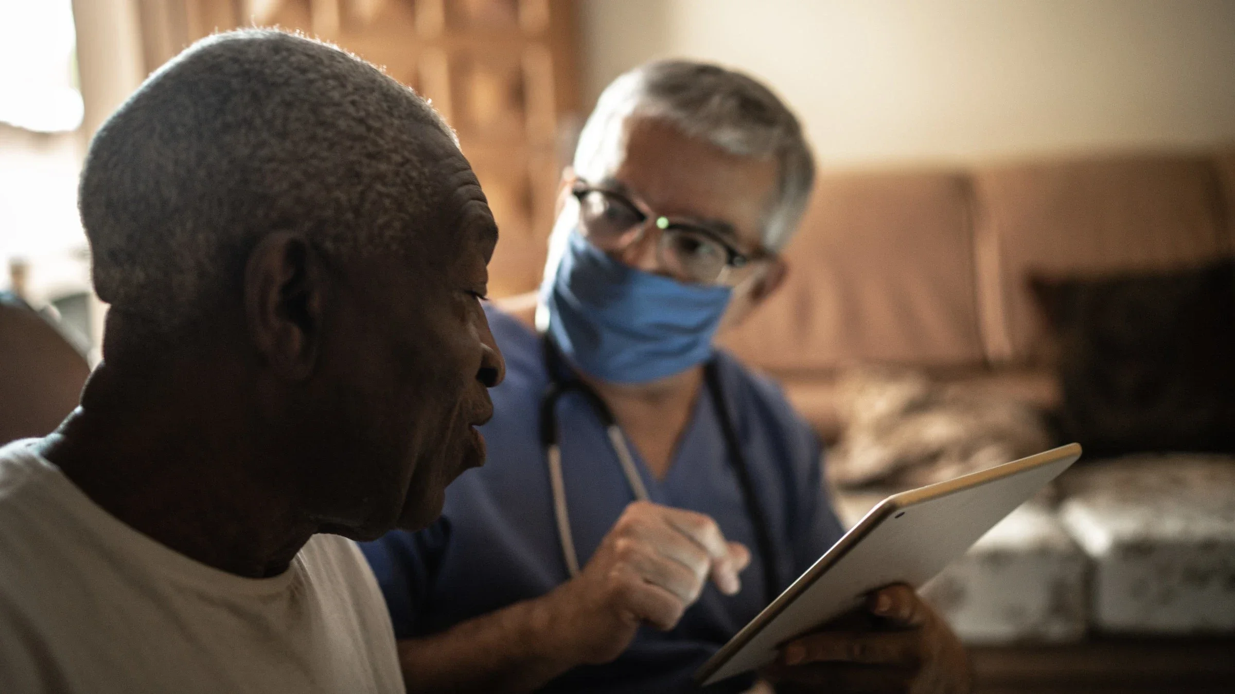 Nurse talking with patient at home going over information on a tablet.
FG Trade/E+ via Getty Images