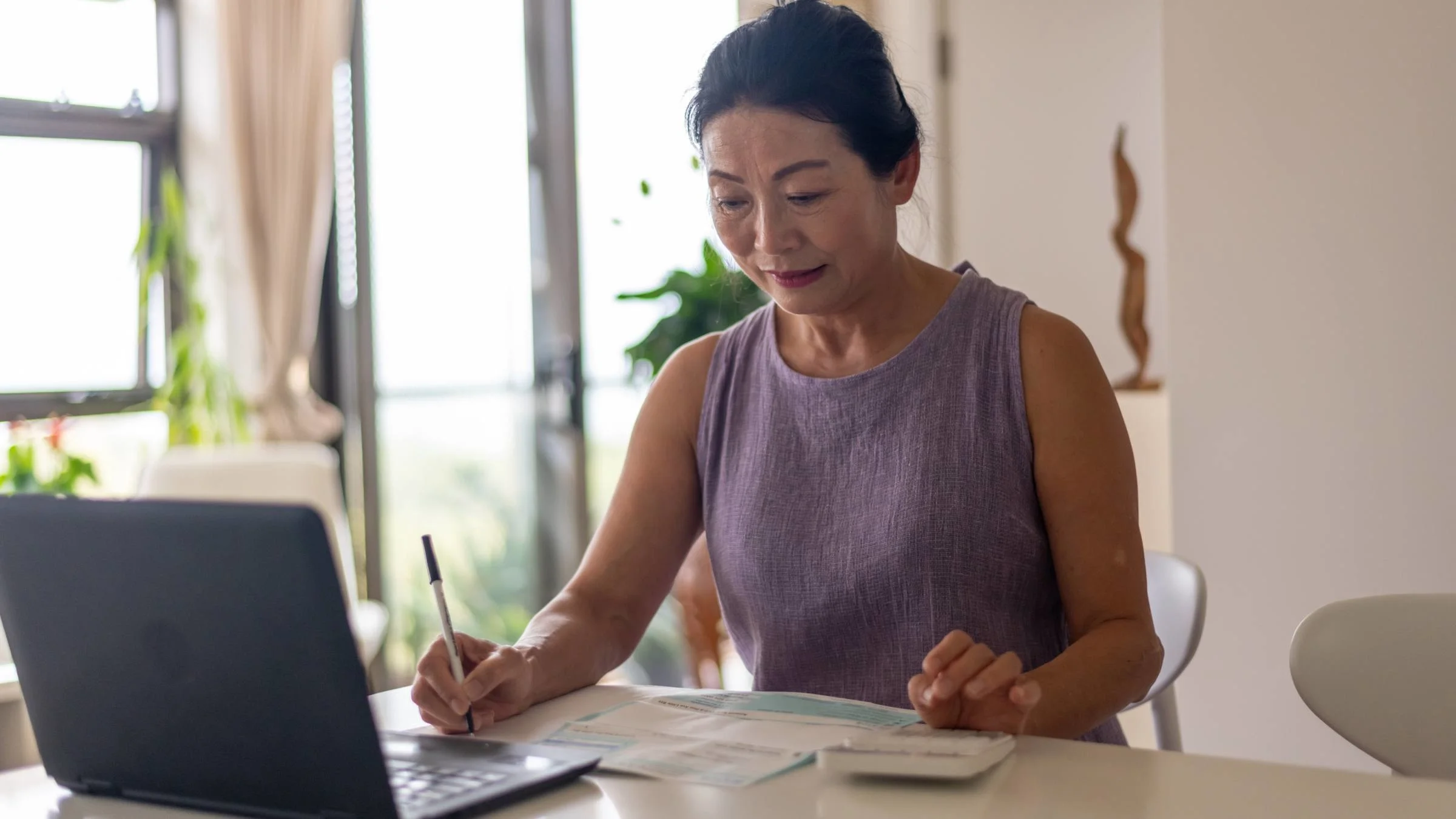 An older adult calculating finances.