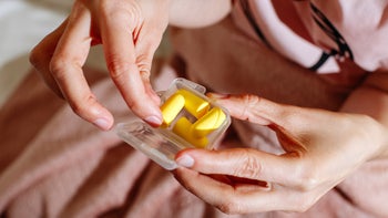 Health: Ear: closeup hands holding ear plugs 1471312869