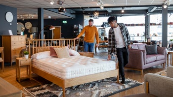 sleep: couple looking at mattress in furniture showroom 1336665196