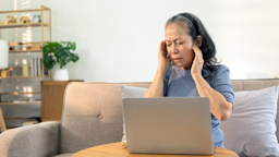 Woman sitting on a sofa with head pain
ArLawKa AungTun/iStock via Getty Images Plus