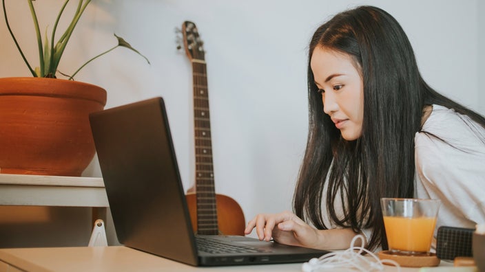 A person navigating a website on their laptop.