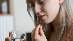 Close-up of someone taking a pill.	
leventince/iStock via Getty Images Plus