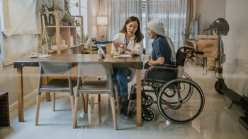 Methotrexate: hcp explaining pill bottle to cancer patient using wheelchair 1364036987
