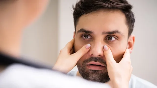 portrait man having sinuses examined-1255007807