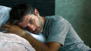 Mental-health: man laying awake in bed 1213416982