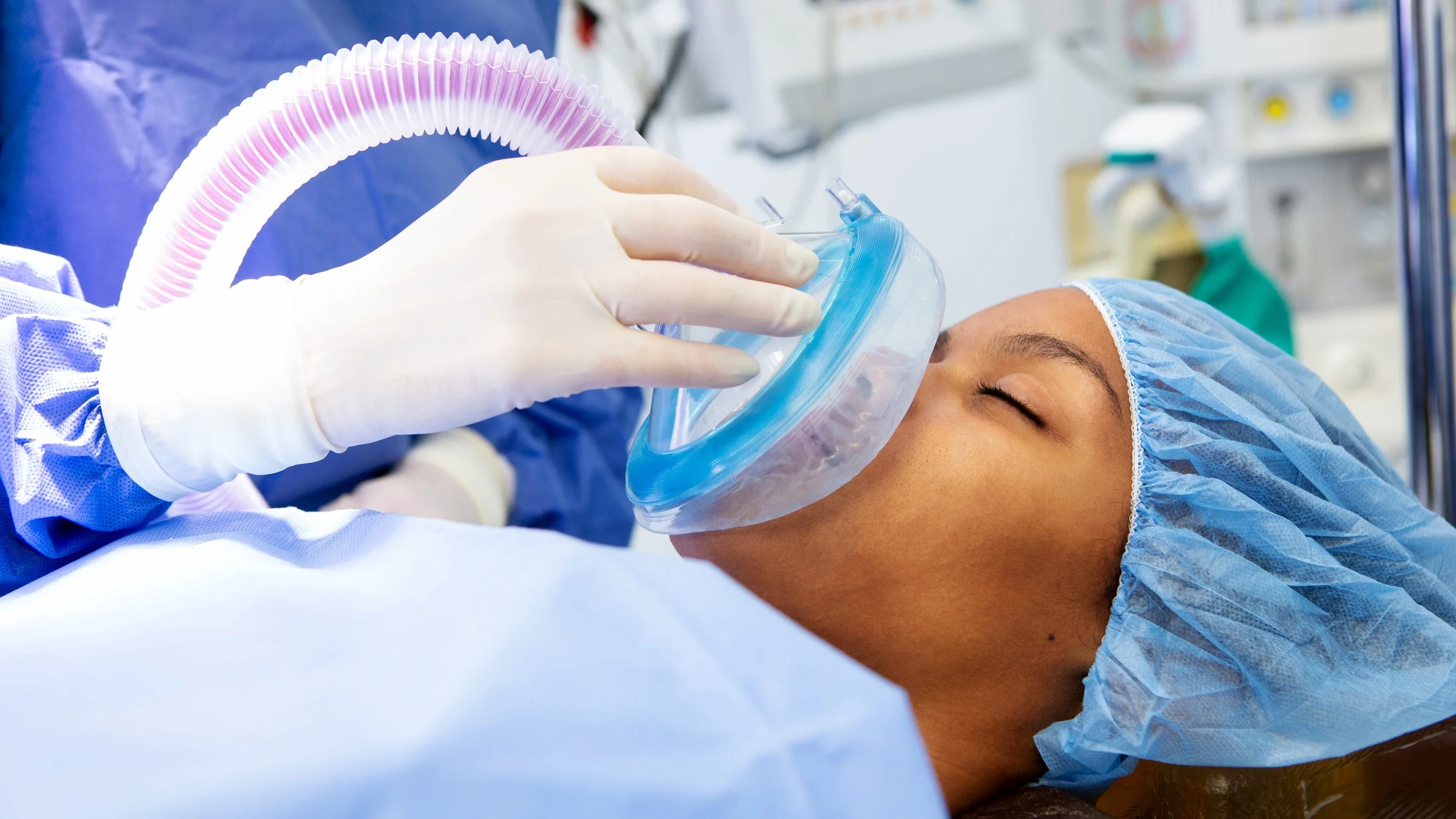Photo of a patient laying in a hospital bed receiving anesthesia