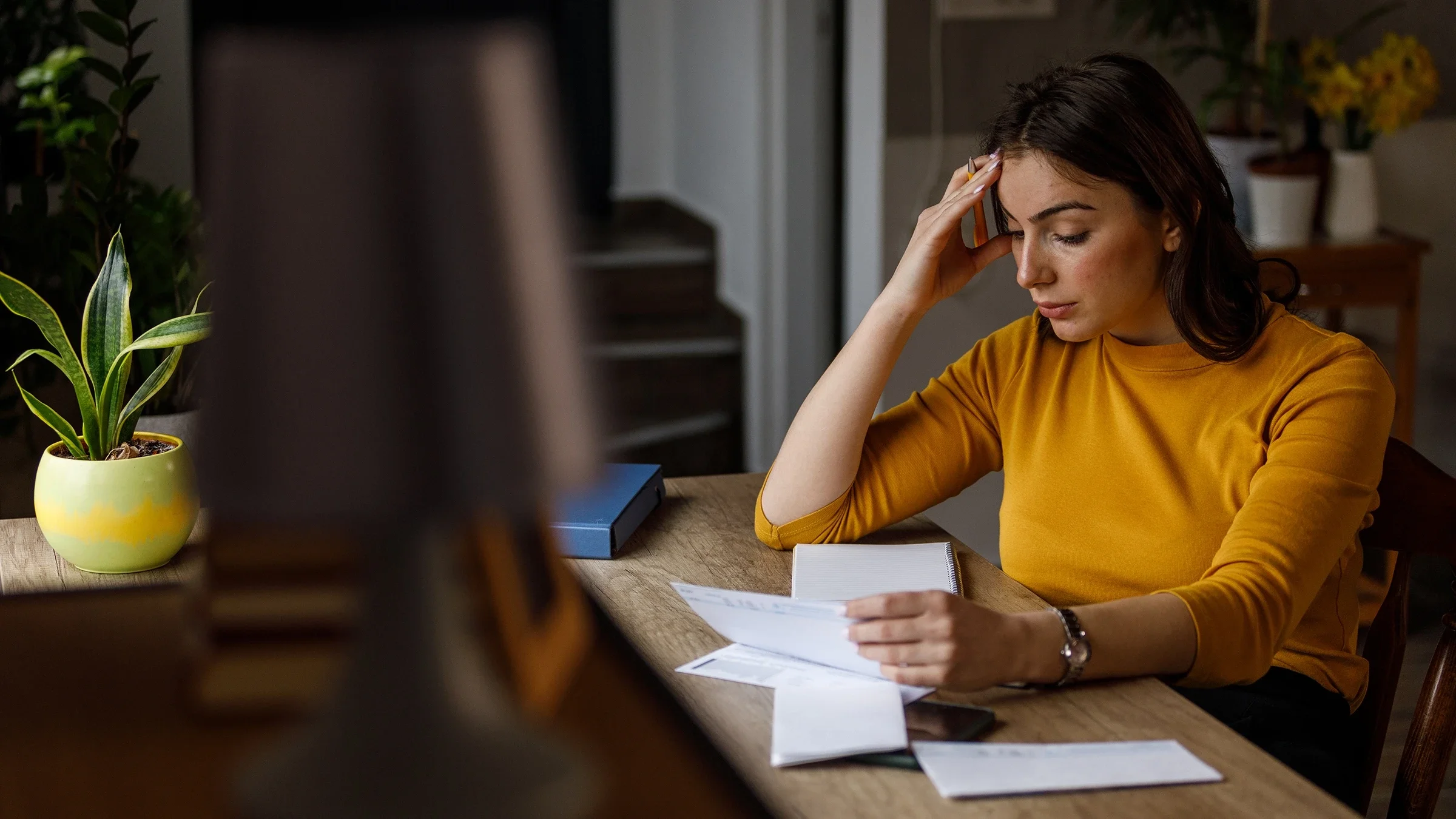 A woman is doing her finances at home.
