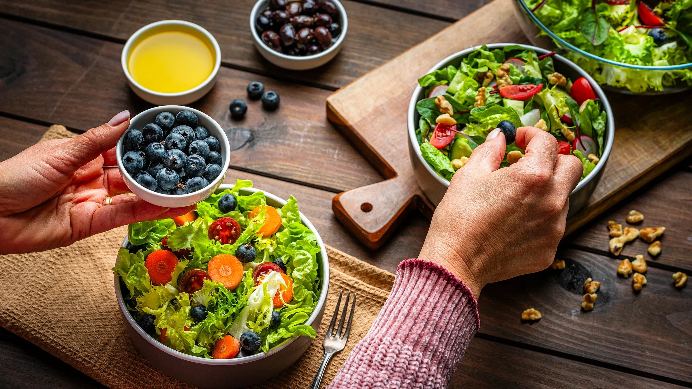 Assembling a salad with blueberries.
fcafotodigital/E+ via Getty Images