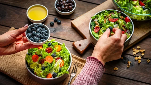 diet-nutrition: assembling salad with blueberries 2267675540