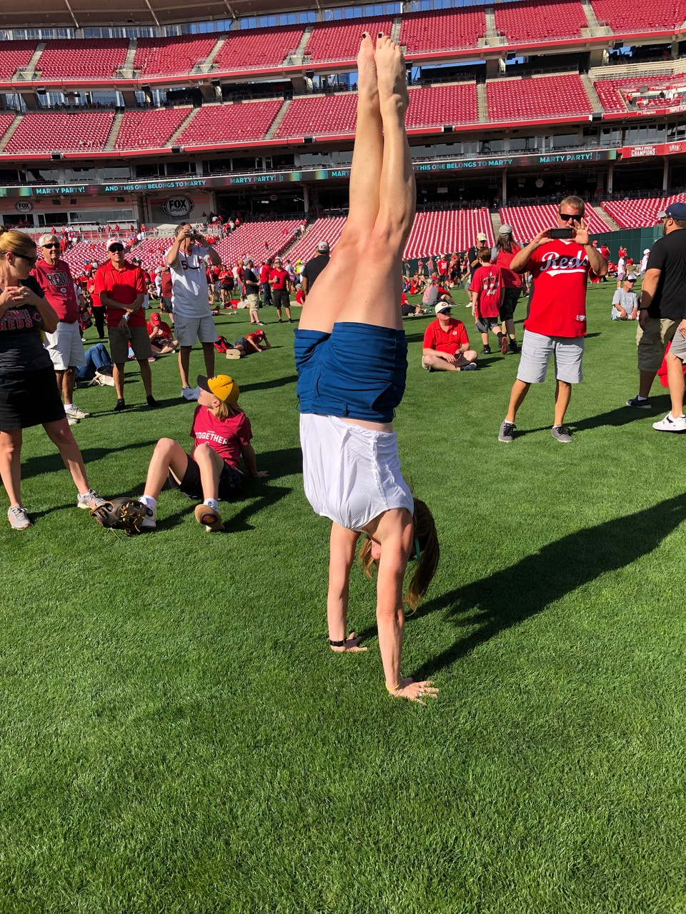Judi Ketteler doing a handstand in a stadium.