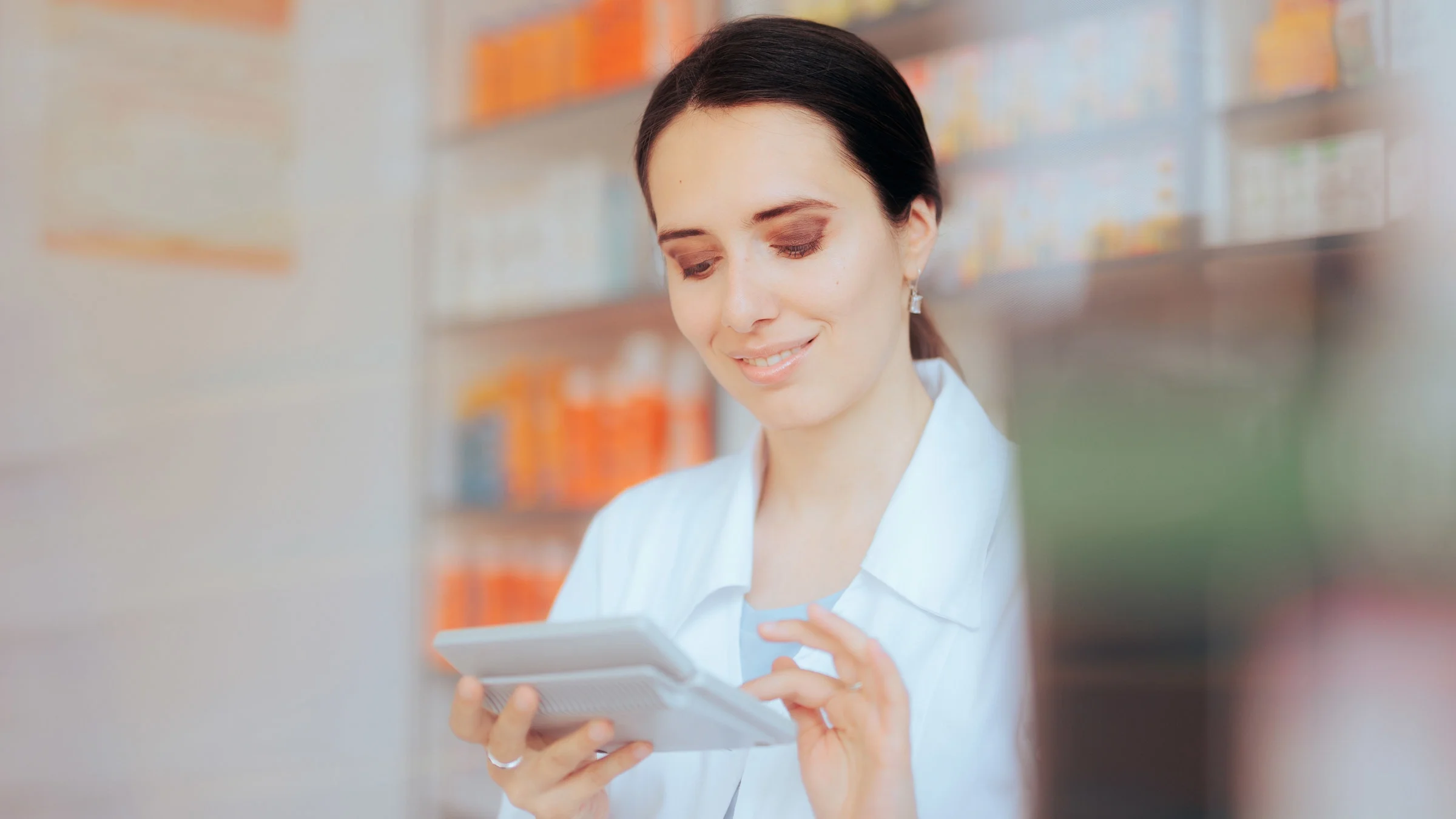 A pharmacist using a calculator.
