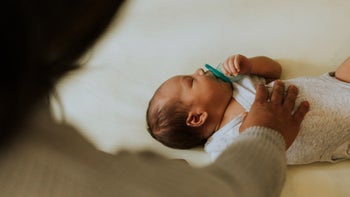 Children's health: checking on sleeping baby 1060797628
