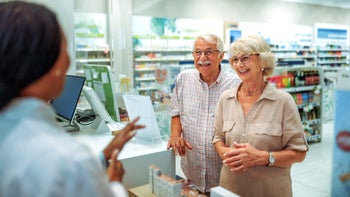 Medicare: senior customer at pharmacy counter 2161651094