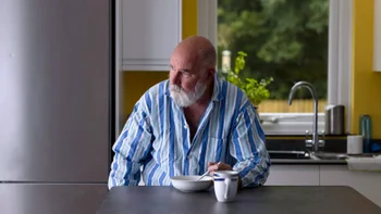 Food Poisoning: tired man eating in kitchen 1331676150