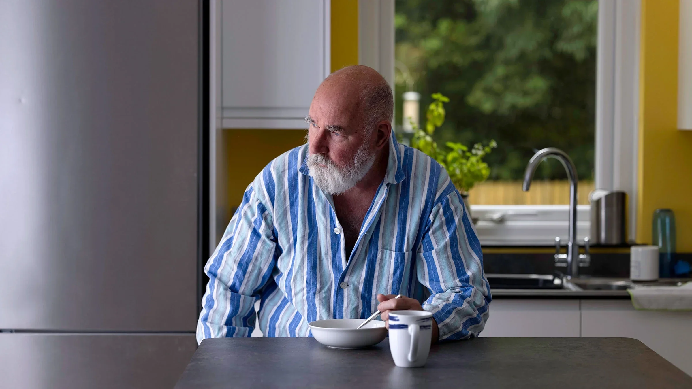 A man recovering from food poisoning is eating soup in his kitchen.
vandervelden/E+ via Getty Images