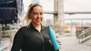 Diet Nutrition: woman drinking from a water bottle 2202233315