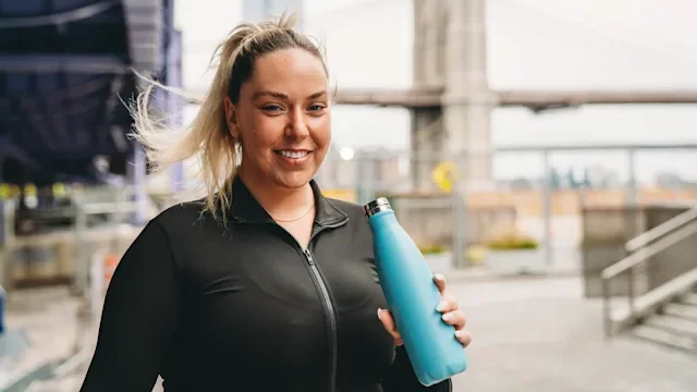 Diet Nutrition: woman drinking from a water bottle 2202233315