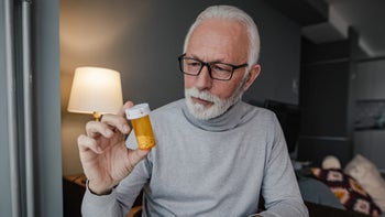 Medication: Pharmacy: Men: older man reviewing prescription bottle 1360589040