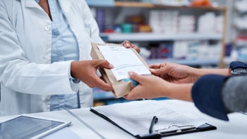 Pharmacy: closeup hands holding prescription 1010456164