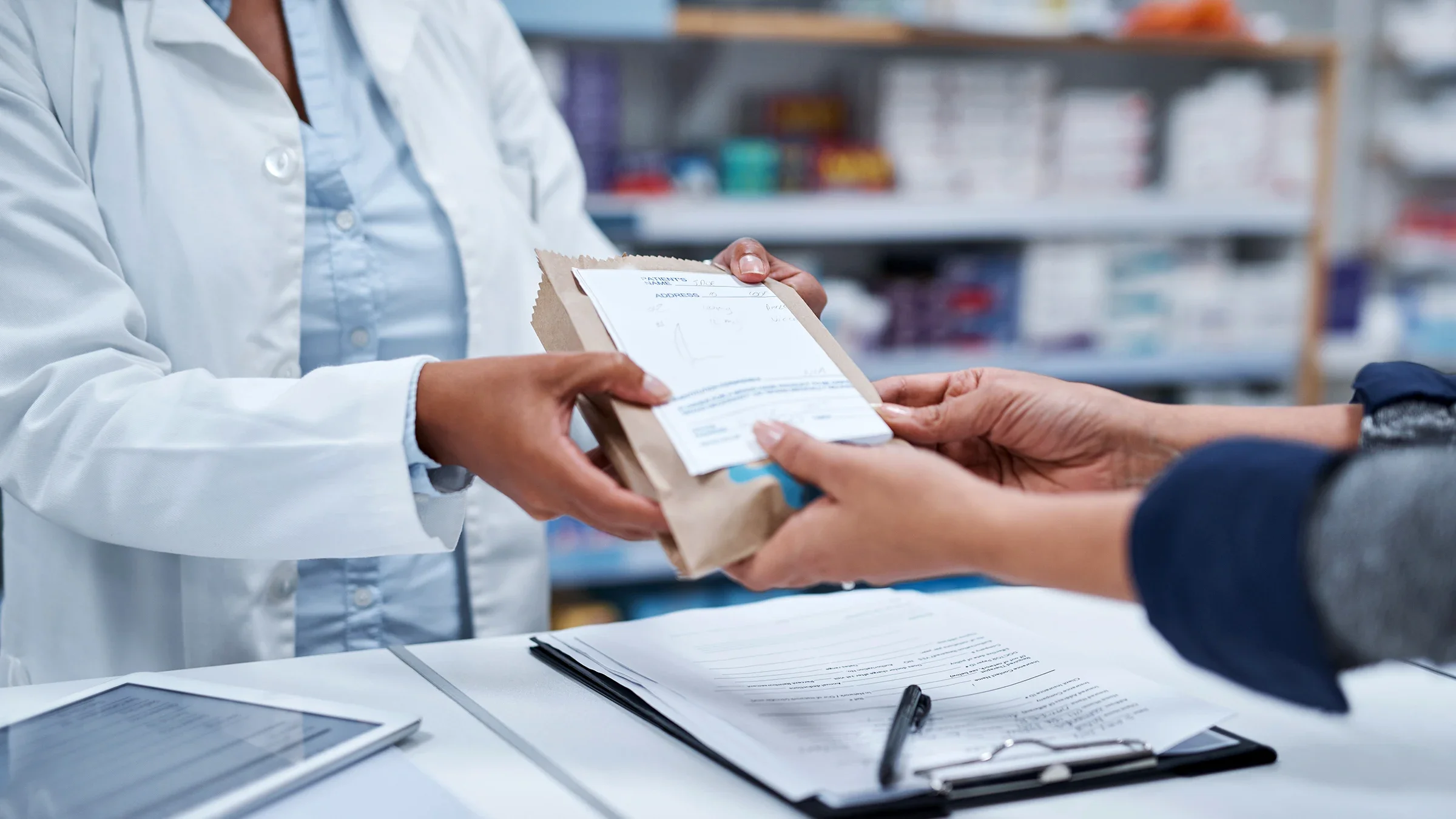 A person receives a prescription from a pharmacist.
Hiraman/E+ via Getty Images