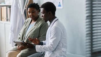 Pharmacy: healthcare professional discusses treatment plan with patient 1463319933