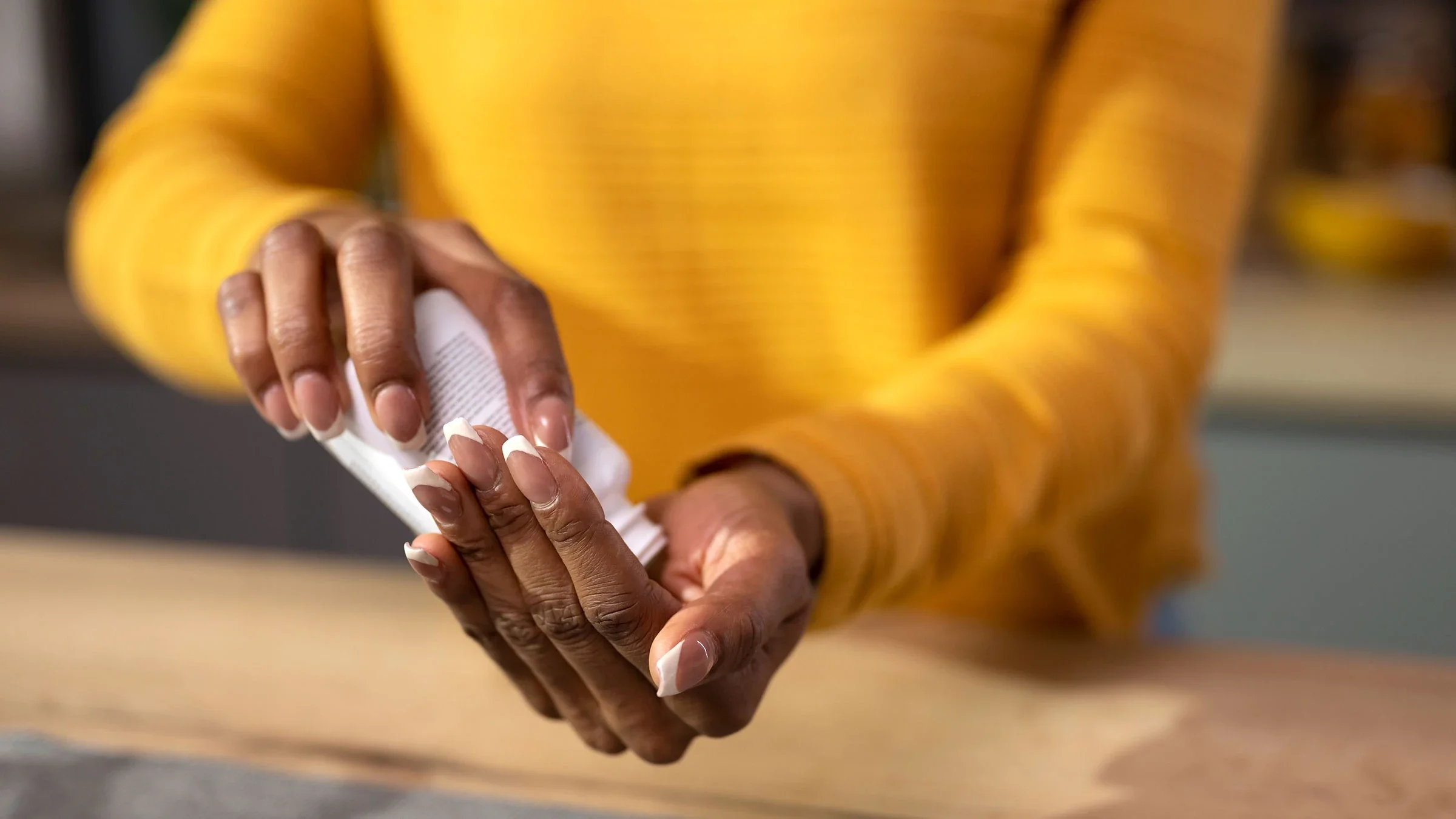 A close-up image shows an adult getting a pill from a bottle.