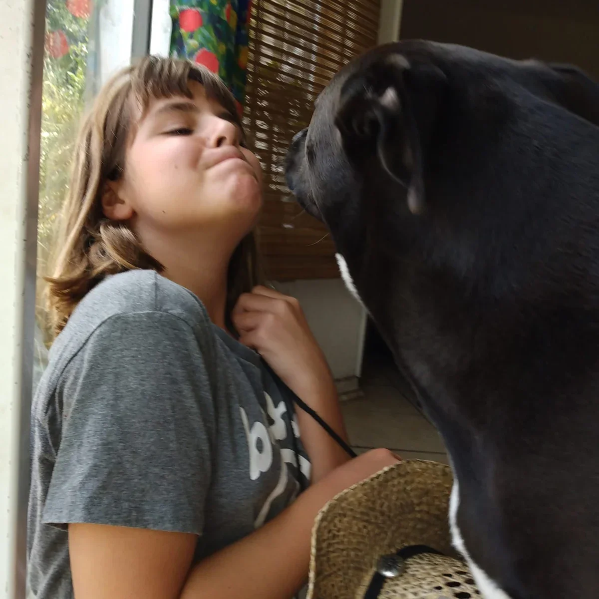 Jennifer Edwards’ daughter Chloe is pictured with their dog Sunday playing in the house.