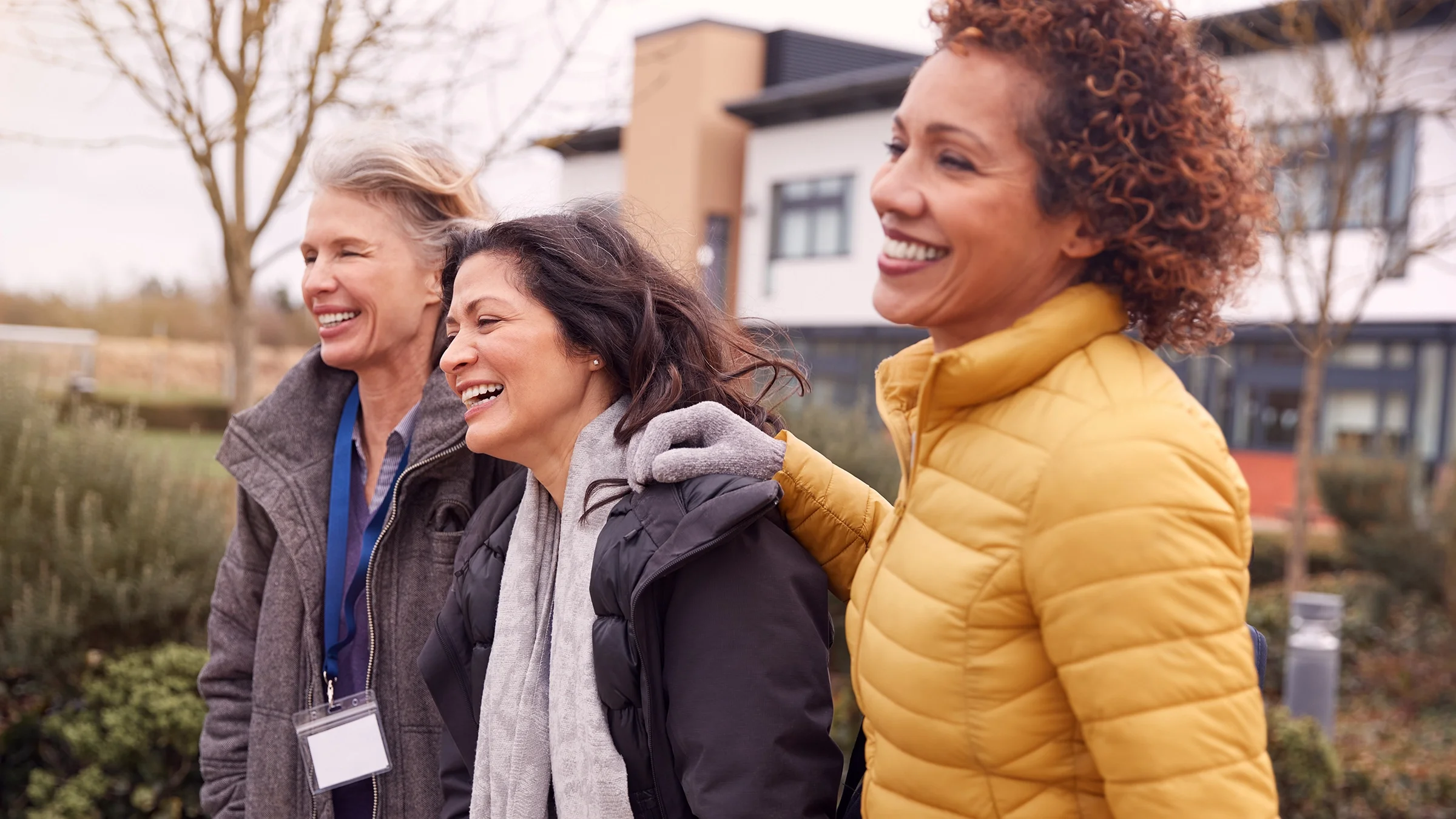 Three adult female friends walking around on a cold chilly.