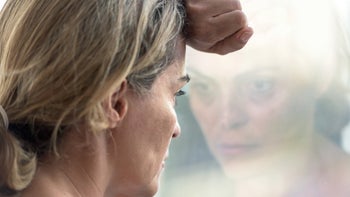 Anxiety disorders: Panic attack: woman anxious looking out window 480705314