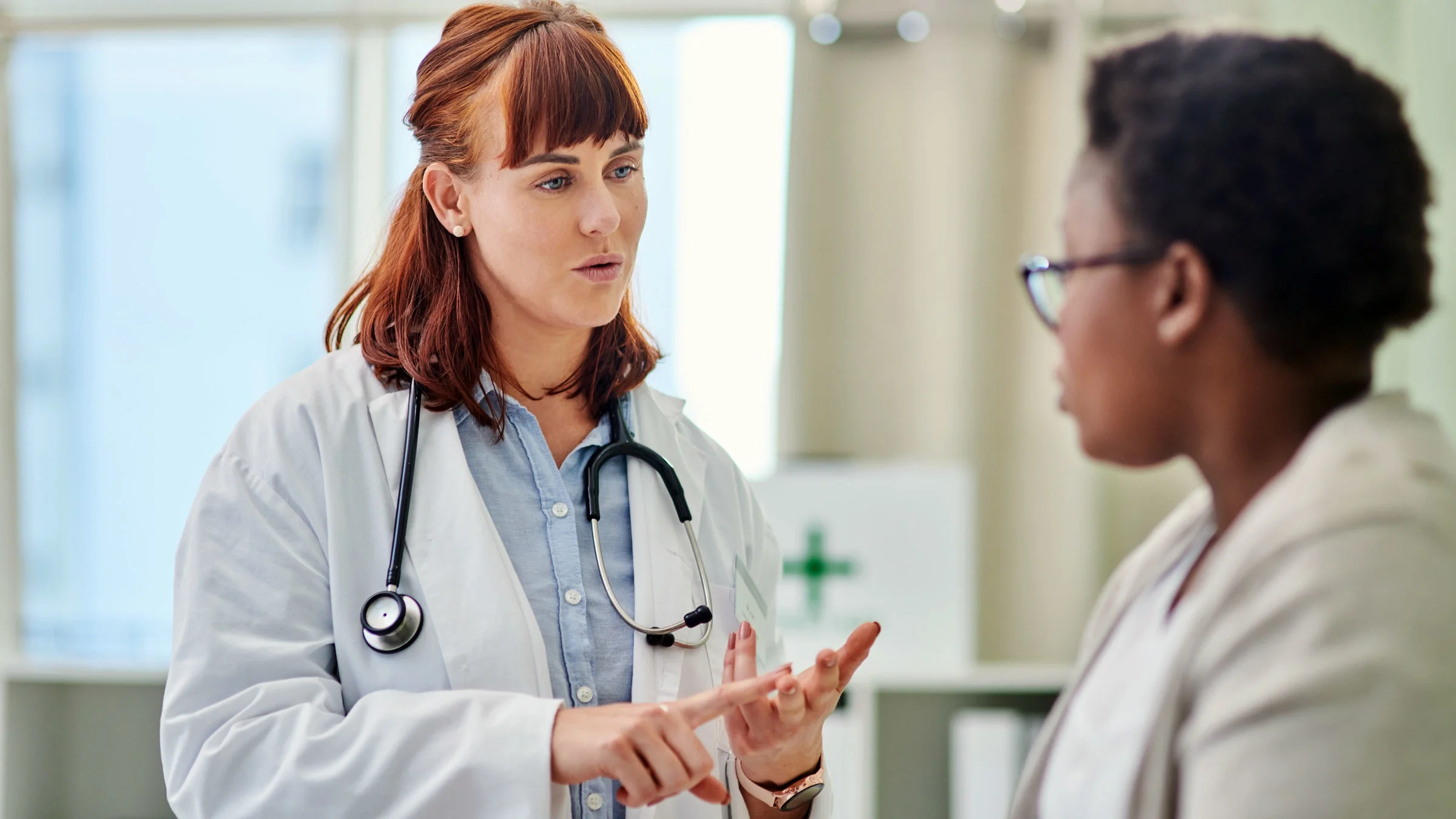A doctor has a consultation with a young woman.