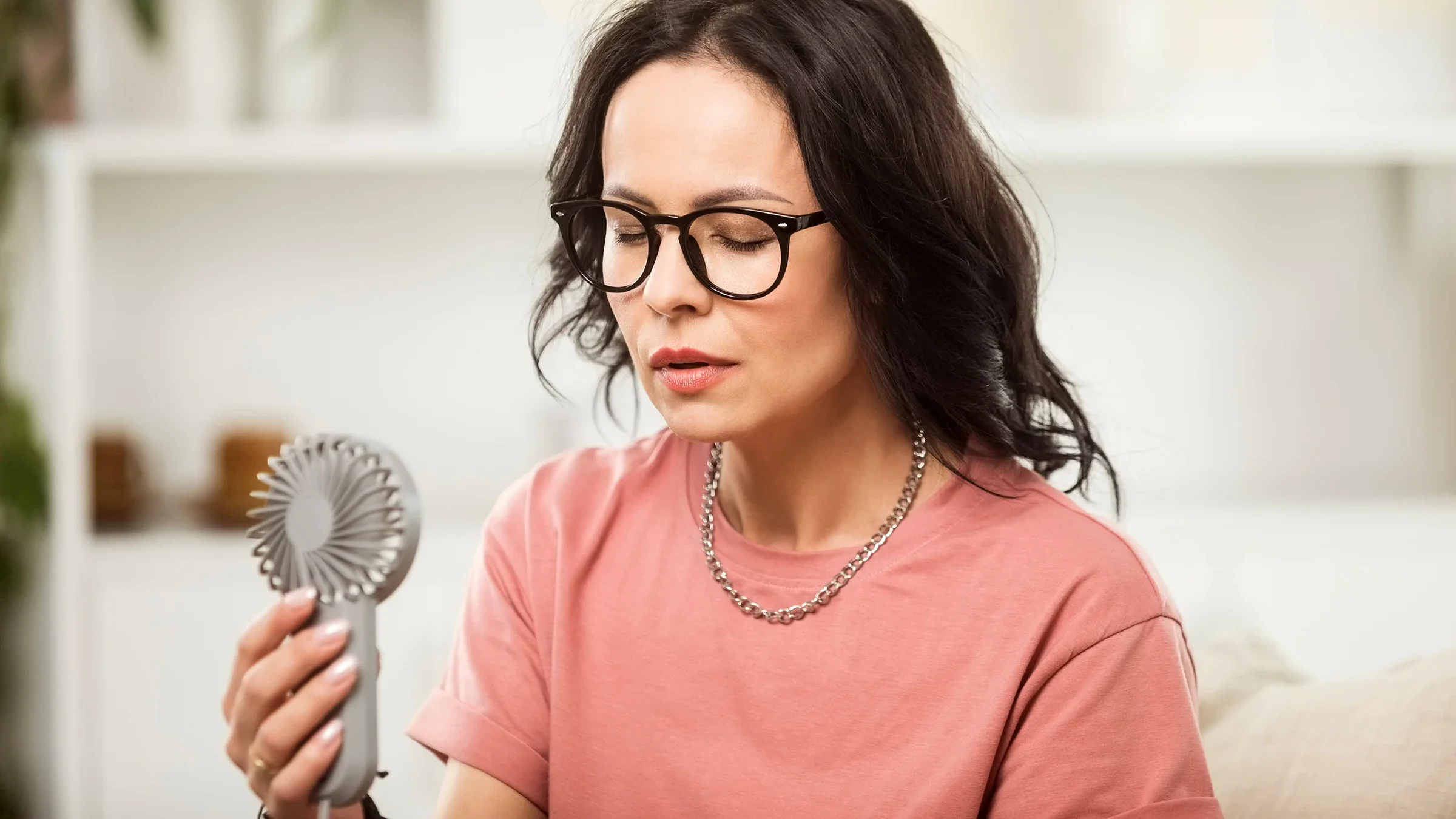 A woman experiencing menopause is having a hot flash.
izusek/E+ via Getty Images