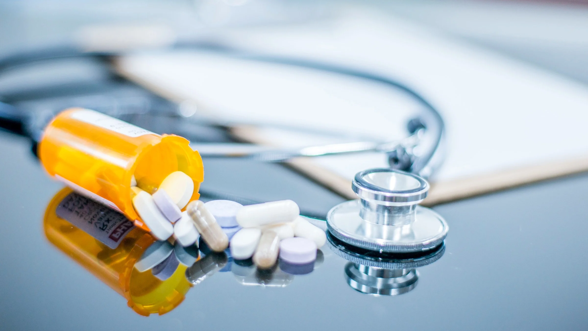 Pills next to a stethoscope.