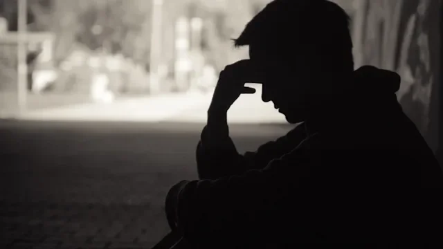 Substance use disorder: Shame: depressed silhouette sitting in tunnel 1138709105