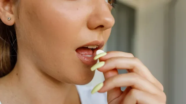 Yeast infection: Diflucan: close-up pill in mouth 1420937952