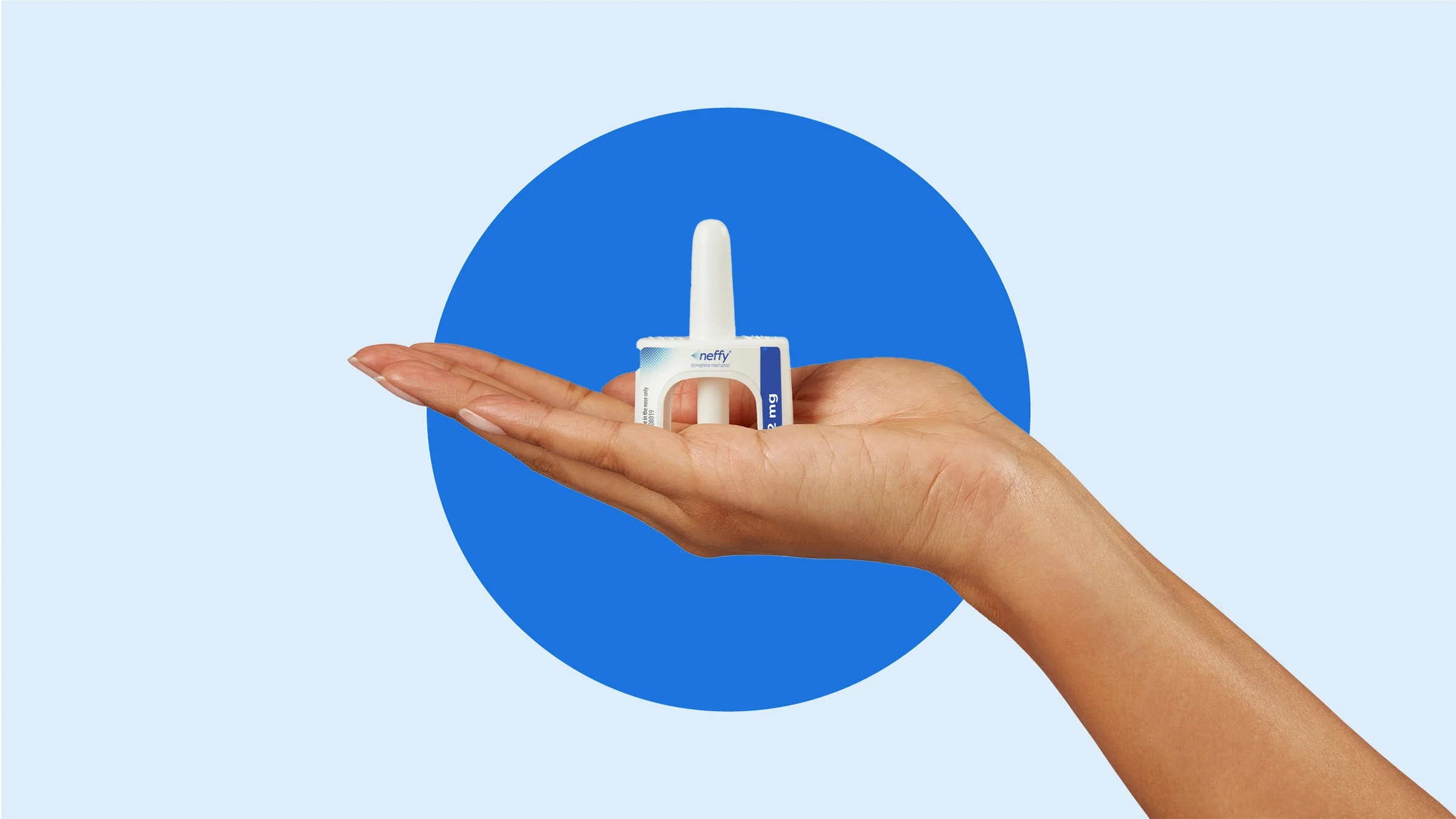 The image shows the neffy product being displayed in the palm of someone’s hand against a blue background.
