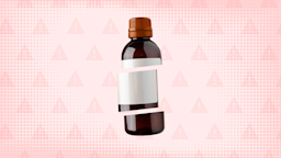 A graphic includes a light-red warning-sign pattern and a prescription bottle with a red cap cut into thirds.
GoodRx Health