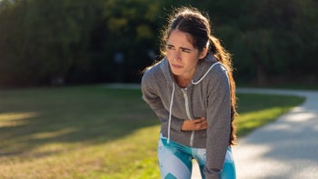 woman cramp stomach pain during run-1368927255