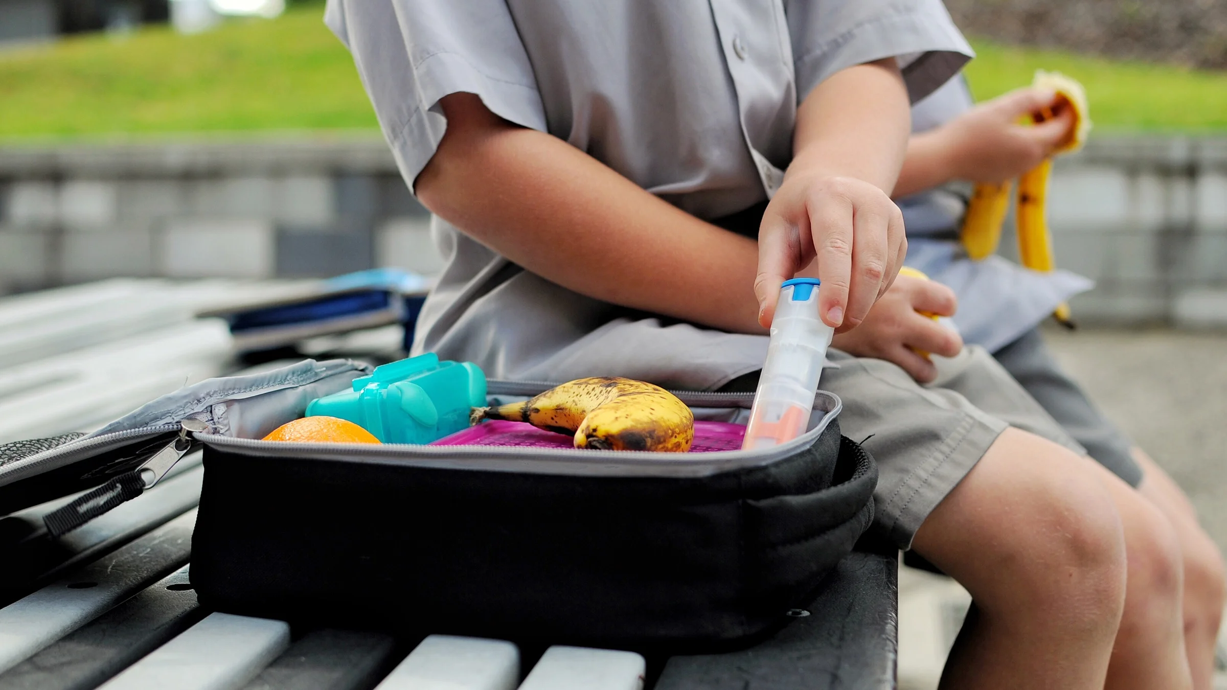 Close-up of an EpiPen in a child's lunchbox.