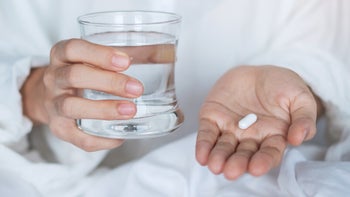 Health: Fluconazole: white pill in hand water glass-1362645847