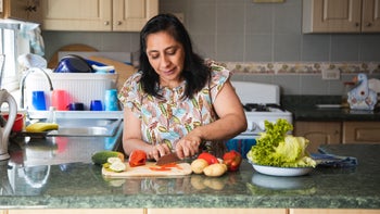 Diet Nutrition: woman slicing vegetables 1306171362