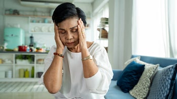 nsaids: headache: sinus: pressure: older woman hands on head headache 1259152650