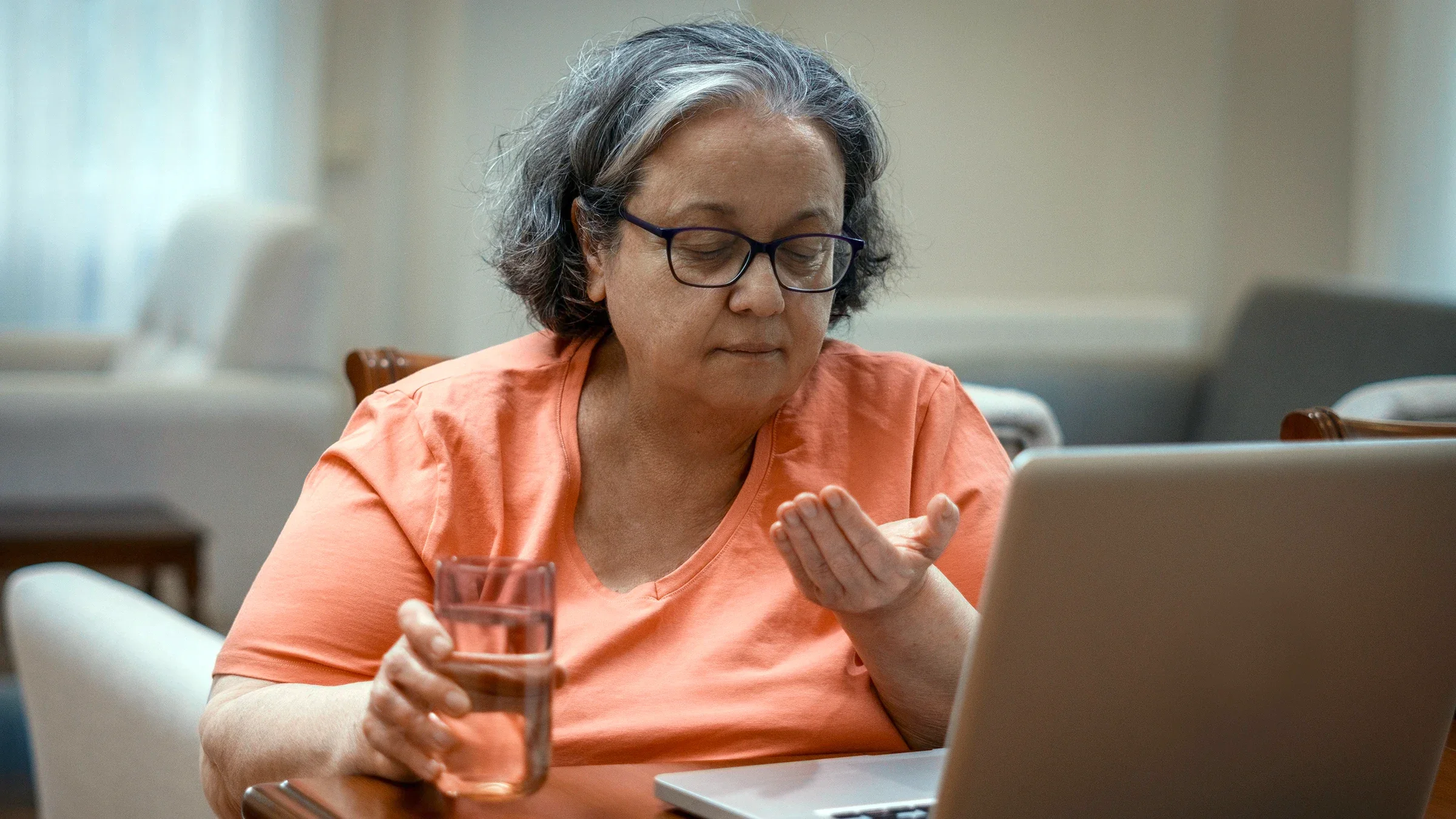 Woman taking medicine at home.
ugurhan/iStock via Getty Images Plus