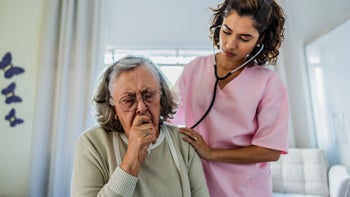 Senior health: examining senior woman with stethoscope 2156064423