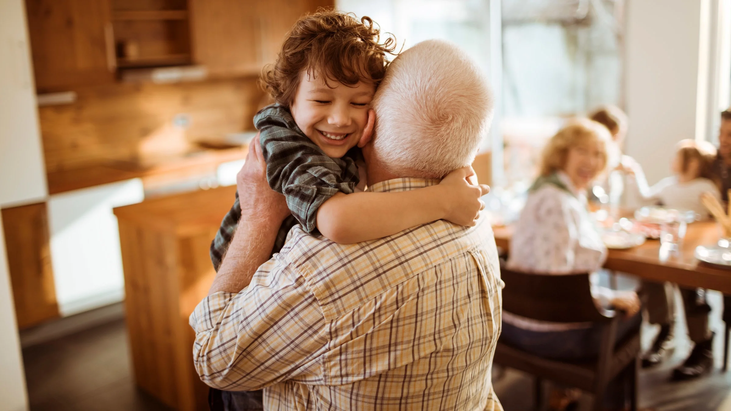 A grandparent hugging their grandchild.