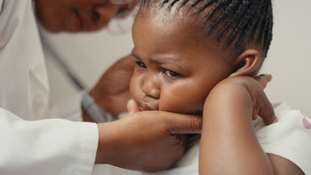 ear infection: doctor checking childs ear 1310015431
