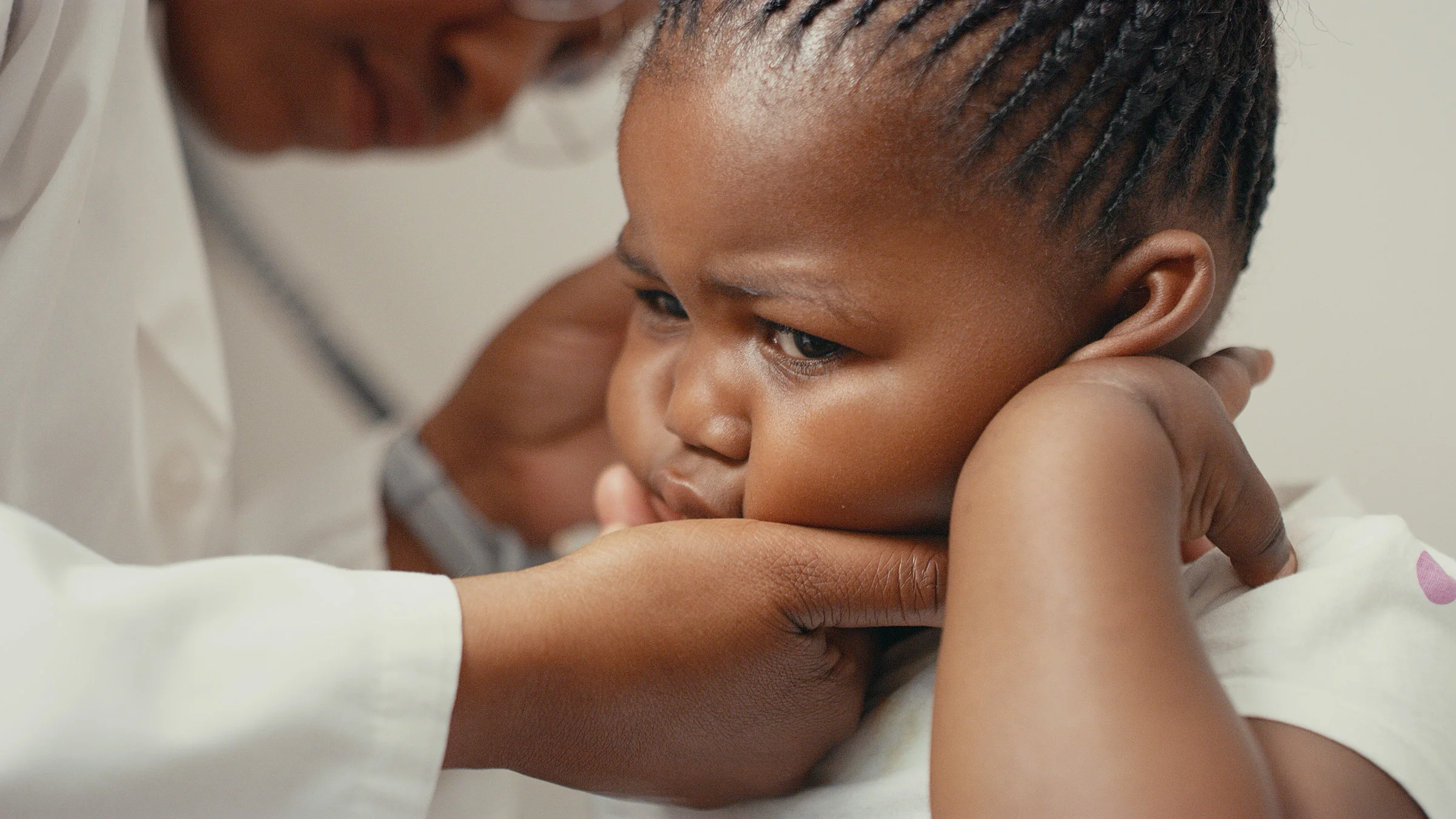 A child having their ear examine by a doctor.