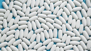 Sucralfate: Interactions: white oblong pills filling frame-1342626717