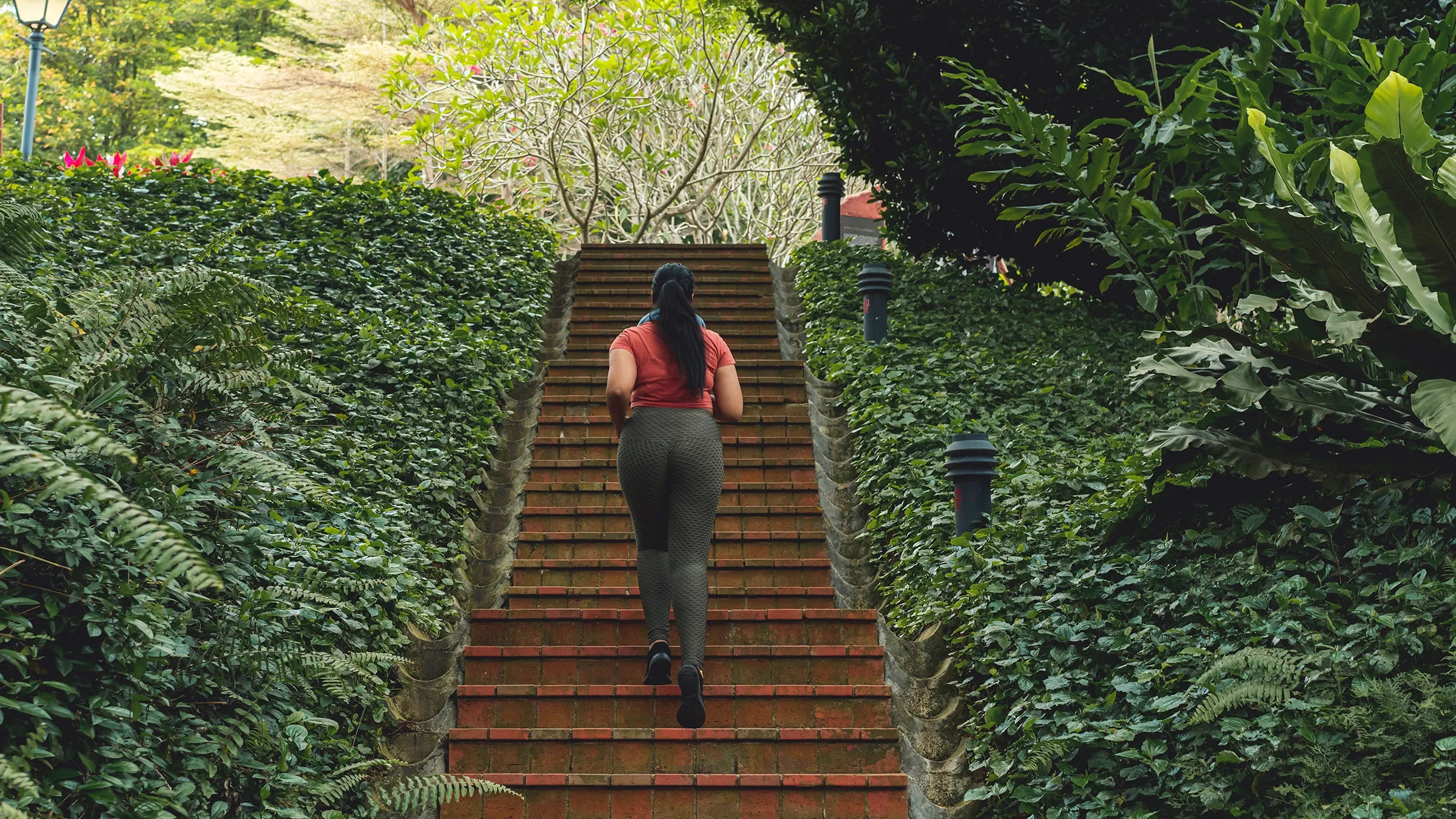 A woman runs up a flight of stairs.